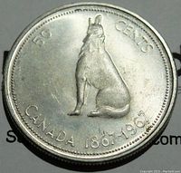 Obverse side of 1967 Canada 50 Cents silver coin showing a howling wolf and inscriptions 50 CENTS, CANADA 1867-1967