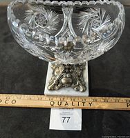 Topside view of crystal bowl showing cut patterns and scalloped rim above ornate base