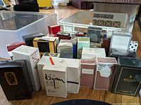 Front view of assorted sealed perfumery boxes on wood floor