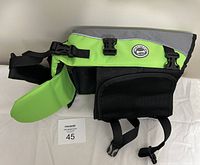 Front side view of the green and grey Vivaglory dog life jacket with multiple black straps and buckles, showing padding and brand logo.