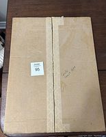 Closed cardboard packaging with taped edges indicating shipment or storage of the newspaper section; marked Globe Jan 19 1877.