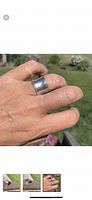 Ring worn on finger showing size and texture.