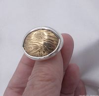 Close-up front view of the Silpada ring showing oval bronze timber inset and sterling silver band.