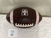 Front angle view of the Wilson leather football showing the brand logo and laces