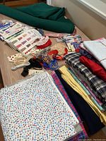 Overview photo showing a variety of fabrics, cording, patterns, and sewing notions spread out on a table.