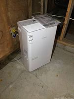 Full view of Noma dehumidifier standing on concrete floor, showing overall condition