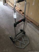 Full view of the lightweight aluminum folding hand cart showing the foam handle and base plate.