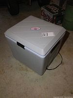 Three different angle photos of Koolatron 12V portable cooler warmer unit showing overall condition, power cord, vents and brand label.