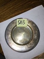 Top view of the silver plate showing surface and monogrammed area