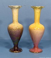 Front view of both vases showing the distinct colored lustre glazes and scalloped rim edges