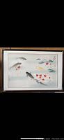 Framed vintage Japanese watercolor painting on silk showing koi fish swimming with lotus flowers, whole artwork visible in frame.