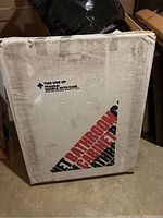 Box with label indicating boxed bathroom cabinet, text reads 'Bathroom Cabinet'.