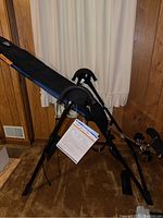 Full side view of the F7000 inversion table showing padded backrest and frame.