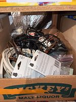 Box filled with mixed electrical wires, cables, and digital timer components