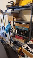 Photo of metal storage shelving unit with boxes and tools placed on shelves to show condition and capacity.