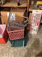 Stacked plastic crates and metal hanging folders with rails showing different colors and types of file folder support frames.