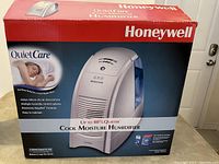 Honeywell QuietCare humidifier box showing branding and features such as quiet operation, multiple humidity controls, and easy maintenance.