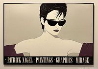 Photo of framed Patrick Nagel poster showing a woman in sunglasses with text 'Patrick Nagel Paintings Graphics Mirage'. Frame shows damage, poster has visible scratches.