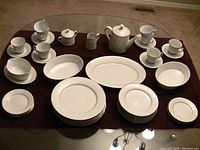 Full set with 46 pieces arranged on table showing all place settings and serving pieces.