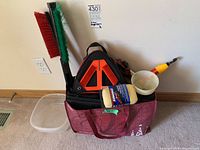Photo showing car supplies including brushes, safety cones, light, funnel, sponge, carry bag and organizer.