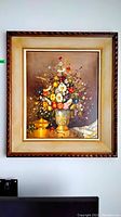 Front view of framed oil painting showing floral arrangement and frame detail