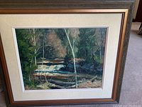 Full view of framed landscape painting showing the river, trees, and frame construction.