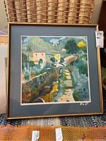 Frontal image of a framed colorful lithograph depicting a rustic scene with houses, path, and stone wall, signed and numbered by Casimiro Tarrasso.