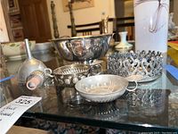 Photo showing the funnel, multiple bowls including Paul Revere reproduction, and two tastevin cups arranged on glass table.