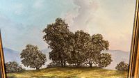 Close-up photo of the painting showing detailed tree cluster and sky with artist signature visible.