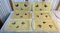 Set of six butterfly themed trays arranged showing front surfaces