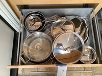 Drawer containing nested All-Clad pots, pans and lids