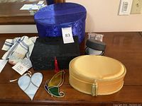 Full view of black decorative box, cream-colored decorative box, round watch case, and two window decor pieces shaped like a heart and butterfly.