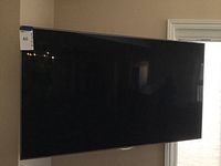 Front view of mounted Samsung 55-inch television on wall