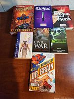 Photo showing Marvel novels including Spider-Man, She-Hulk, Rogue Touch, Wolverine, Civil War, Hulk, and Dr. Brain novels