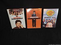 Front view of DVD cases for Arrested Development Season 1 and 2, and Corner Gas Season 1 showing cover art and titles