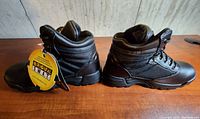 Side view of Original S.W.A.T. tactical boots with tag visible, showing leather and textile material and sole.