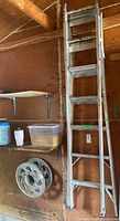 Full view of aluminum combination ladder standing in garage, showing it in an extended A-frame position.