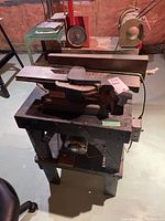 Full view of National Power Tools planer model 60 on wooden stand in a basement setup.