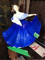 Full view of Royal Doulton Elaine figurine in blue dress with fan.