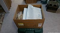 Full cardboard box filled with assorted stamps and stamp books
