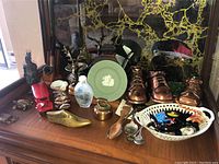 Full display of various small collectible and decorative items on wood