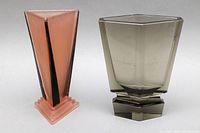 Front angle photo showing taller smoked glass vase and shorter pink and black glass vase to display their shapes and condition.