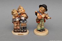 Front view of two Goebel figurines showing detailed facial expressions and clothing