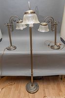 Full view of the 58 inch floor lamp with three etched glass shades and two 23 inch table lamps with two etched glass shades each, showing metal bases and decorative arms.