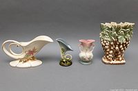 Four Hull USA pottery vases and planter arranged in a row showing front view, from tallest to shortest.