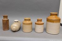 Full set of 5 stoneware pieces shown upright side-by-side: 4 crocks and 1 foot warmer.