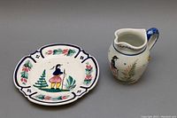 Photo of vintage Henriot Quimper creamer and plate showing hand-painted folk art design, minor crazing visible