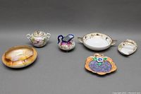Set of 6 vintage Japanese porcelain items including Noritake and Nippon pieces arranged on gray background.