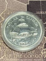 Obverse photo of 1979 Canadian silver dollar coin showing sailing ship and dates 1679-1979.