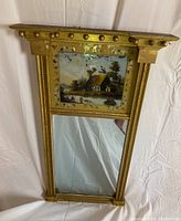 Full view of the gilt wood mirror showing rectangular shape with a hand painted upper panel and lower mirror glass section.